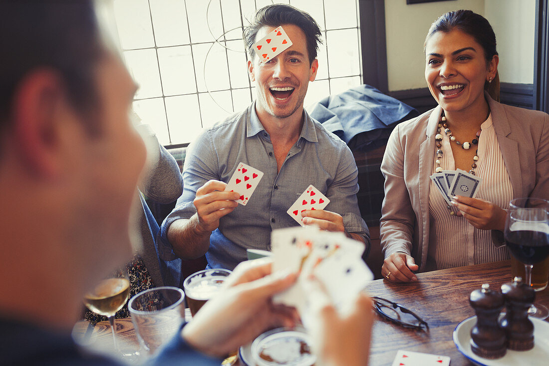 Friends playing Blind Man's Bluff at bar