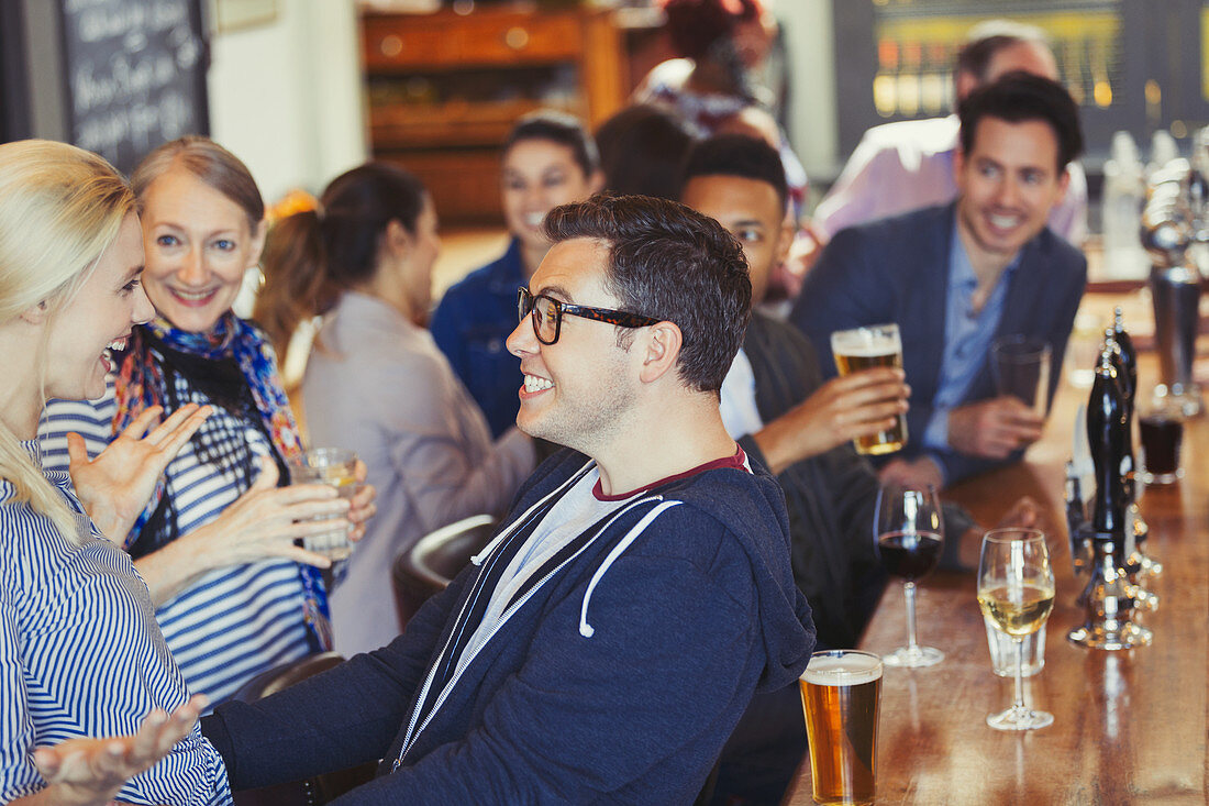 Enthusiastic man and woman greeting in bar