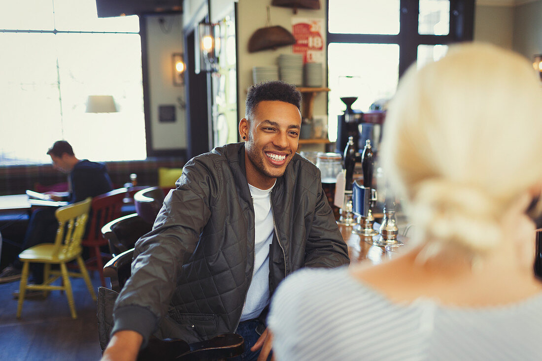 Man talking to woman in bar