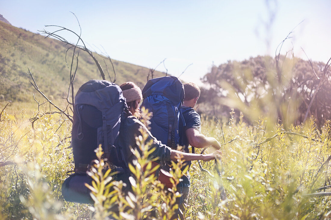 Young couple with backpacks hiking