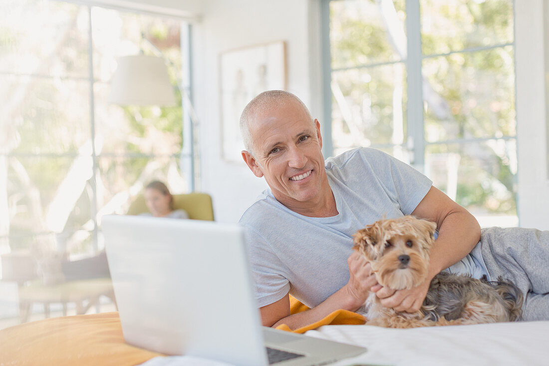 Portrait smiling man petting dog