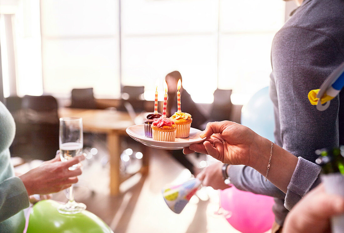 Businesswomen giving birthday cupcake