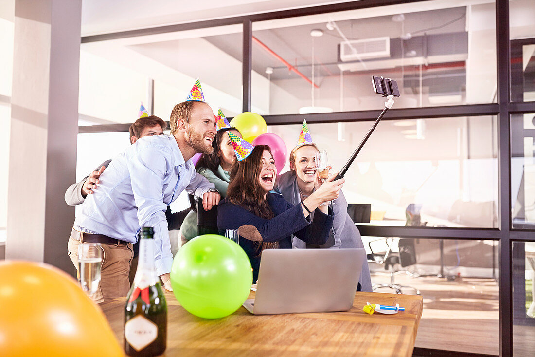 Playful business people celebrating birthday