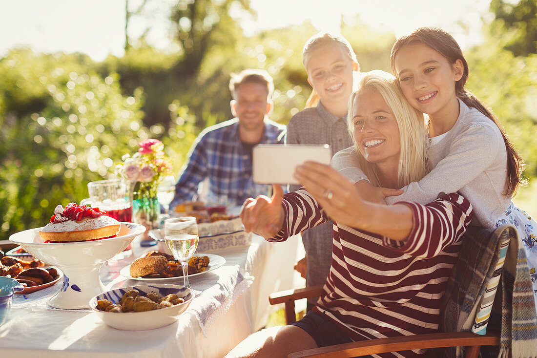 Mother and daughters taking selfie