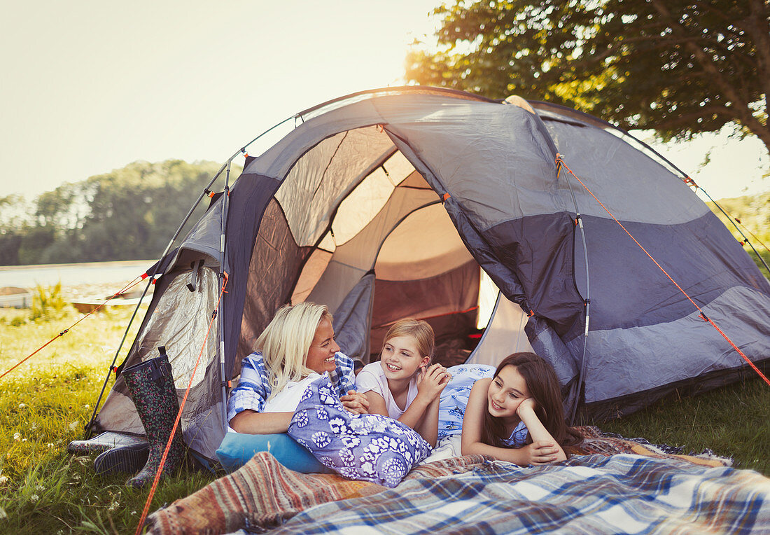 Mother and daughters talking and relaxing in tent