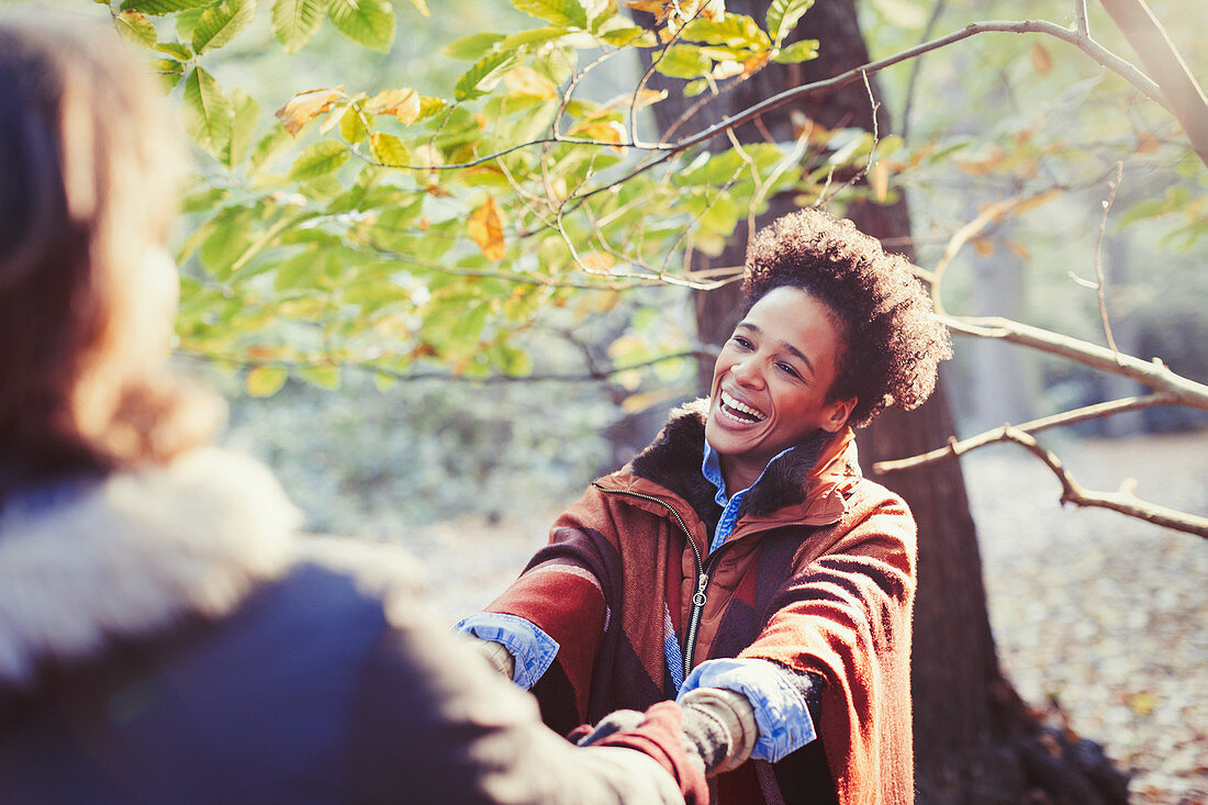 Happy woman holding hands with boyfriend