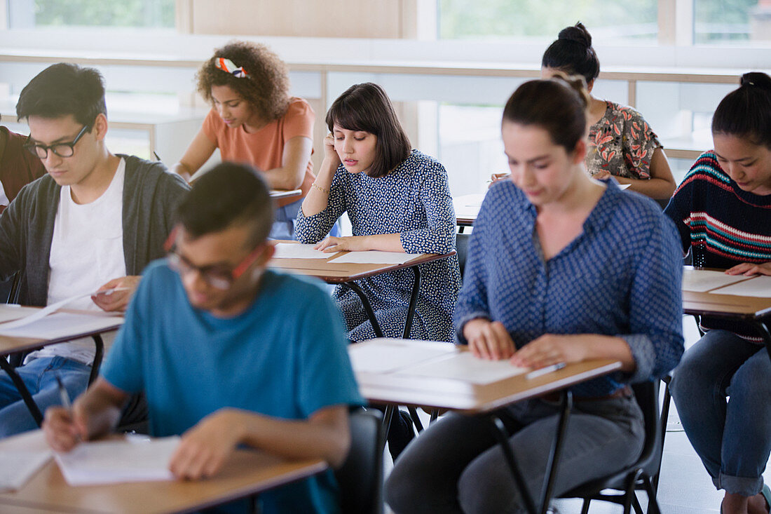 College students taking test at desks