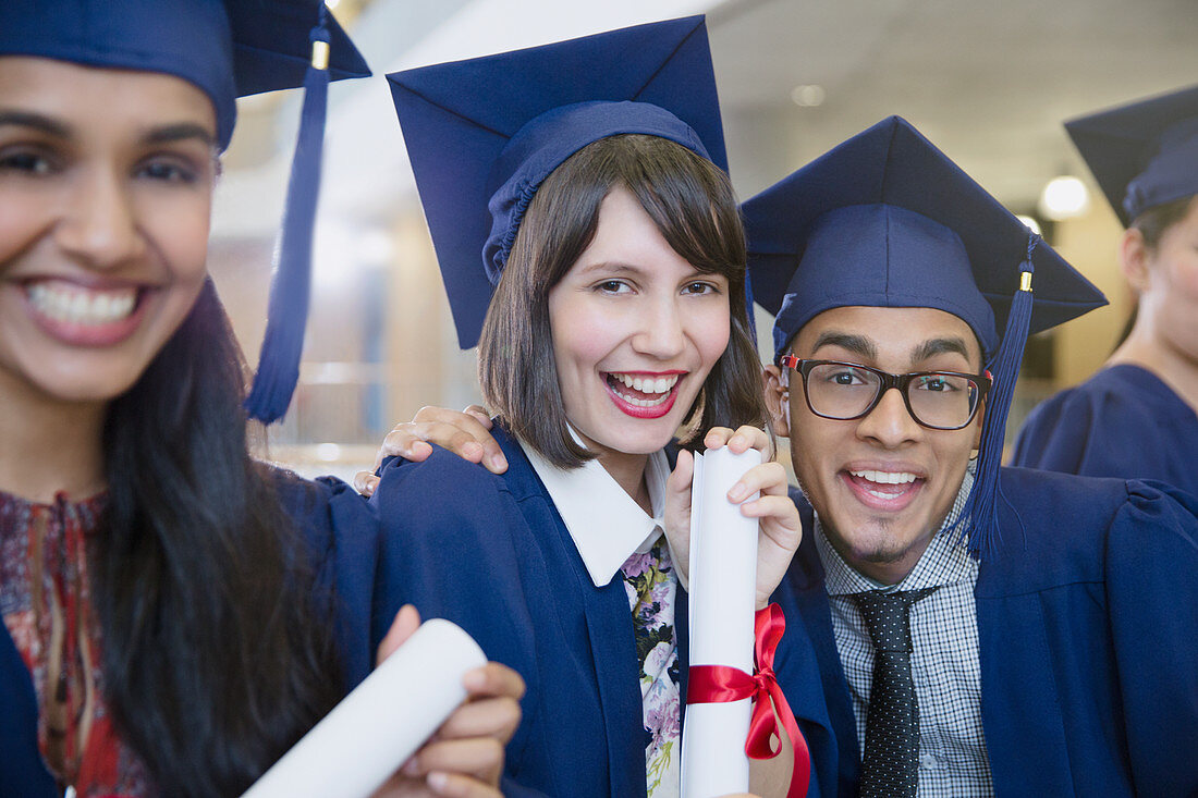 College graduates in cap and gown posing