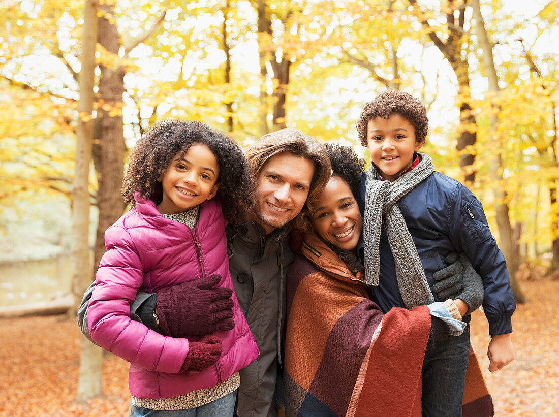 Portrait young family in autumn park