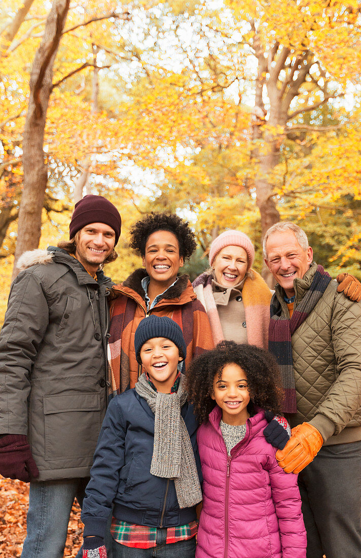 Portrait multi-generation family in autumn woods