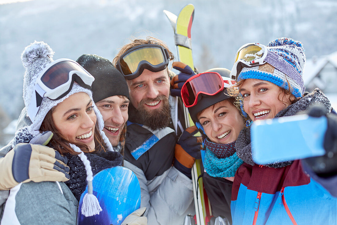 Smiling skier friends taking selfie