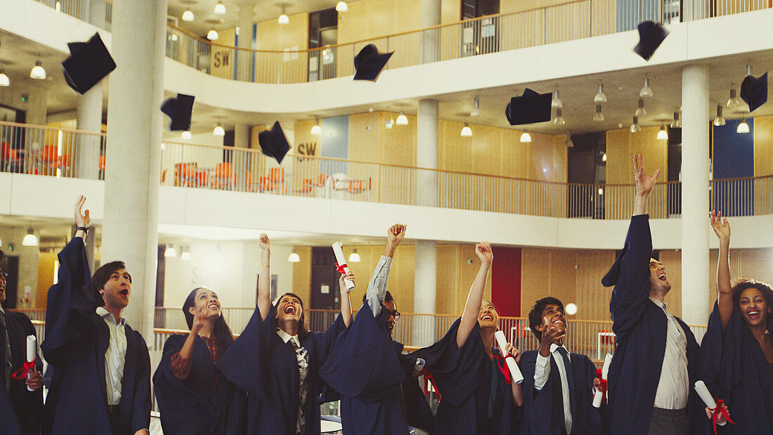 College graduates throwing cap