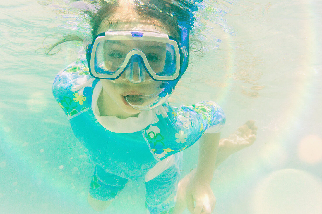 Portrait girl snorkelling underwater