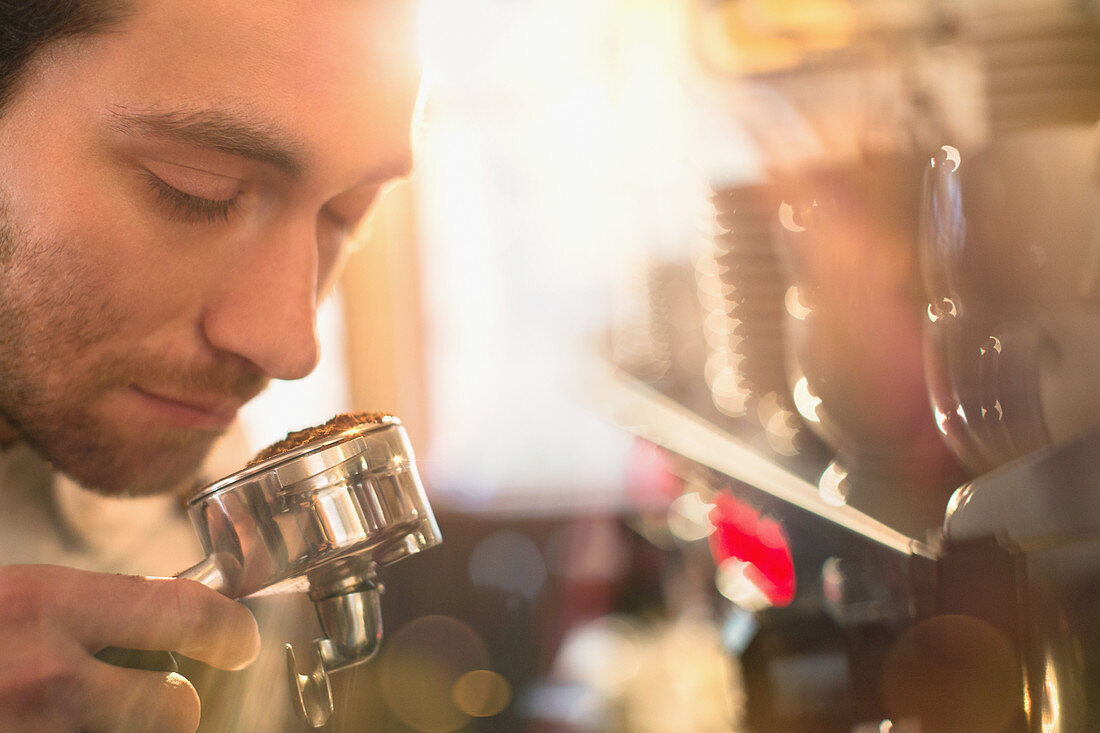 Close up barista smelling espresso grounds