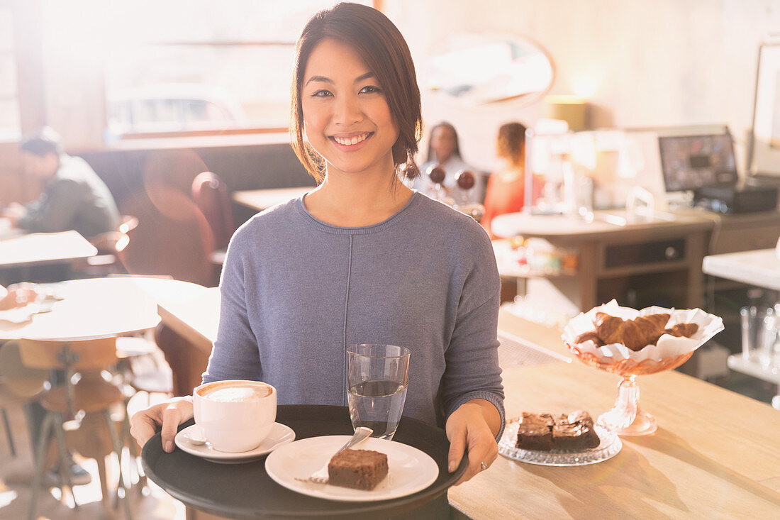 Waitress carrying tray with cappuccino
