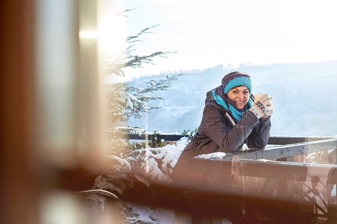 Portrait smiling female skier drinking hot cocoa