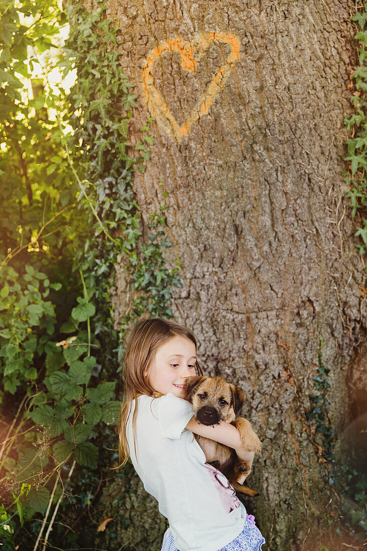 Girl holding puppy dog