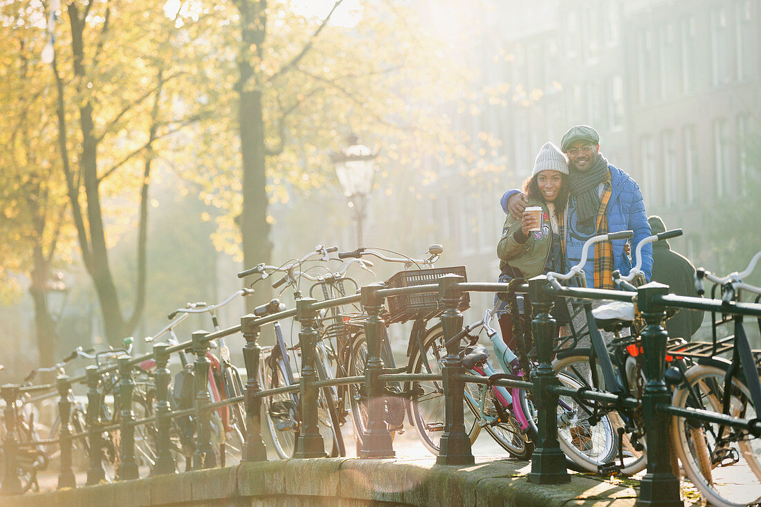 Young couple drinking coffee along bicycles