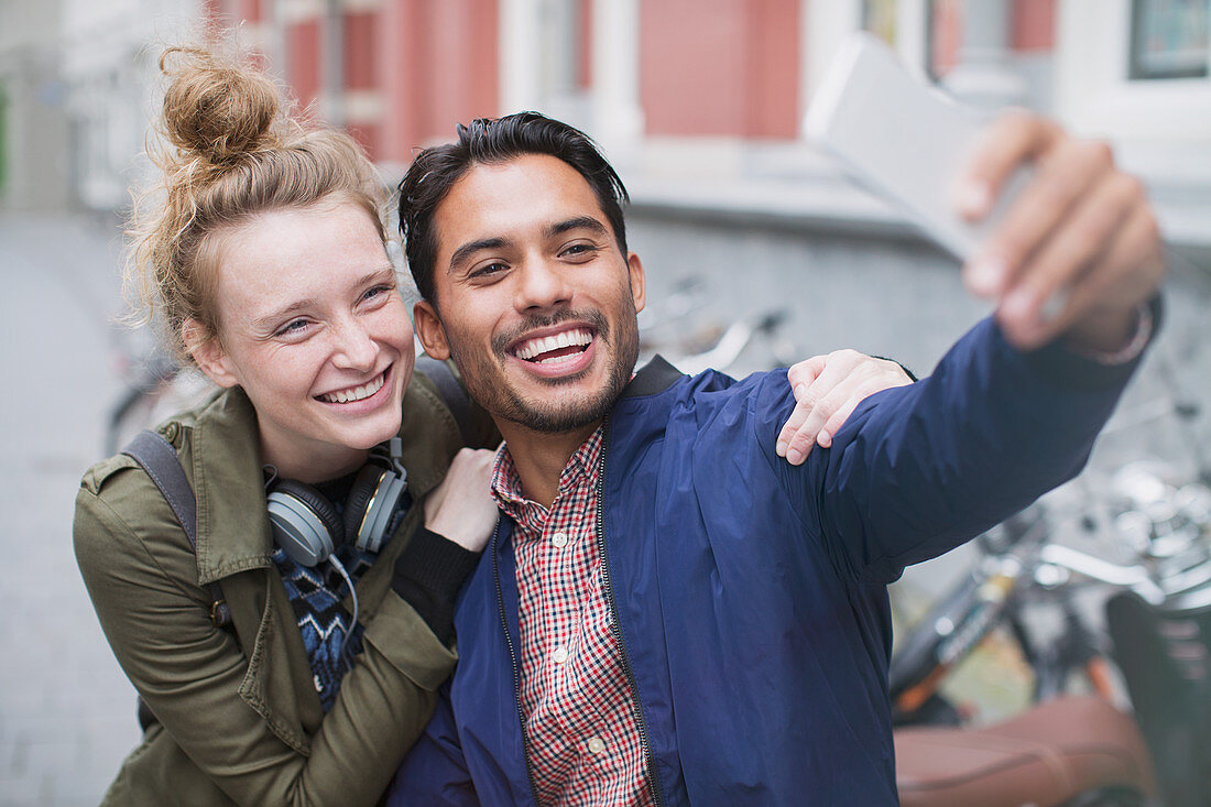 Smiling young couple taking selfie