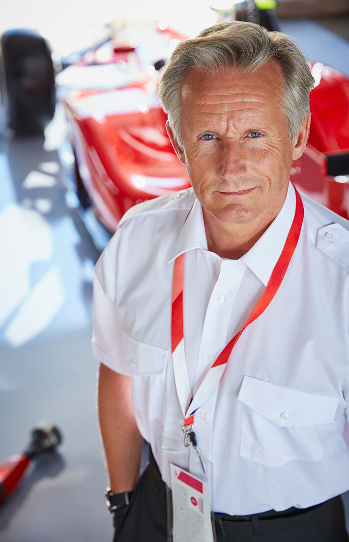 Formula one racing manager in repair garage