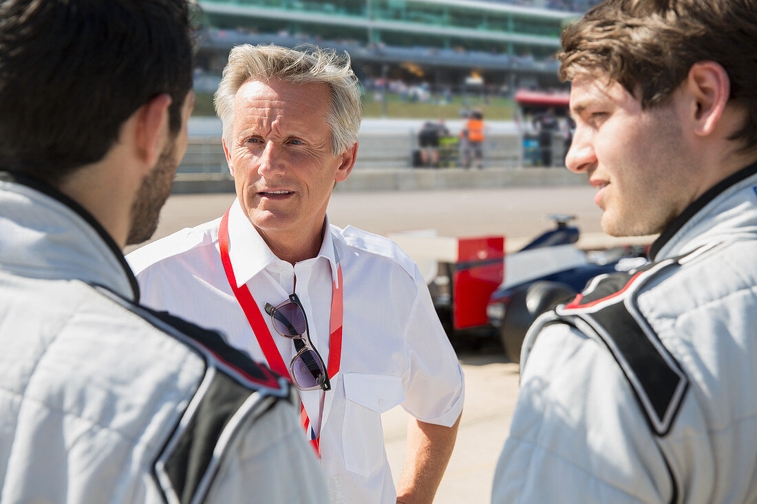 Manager talking to formula one drivers