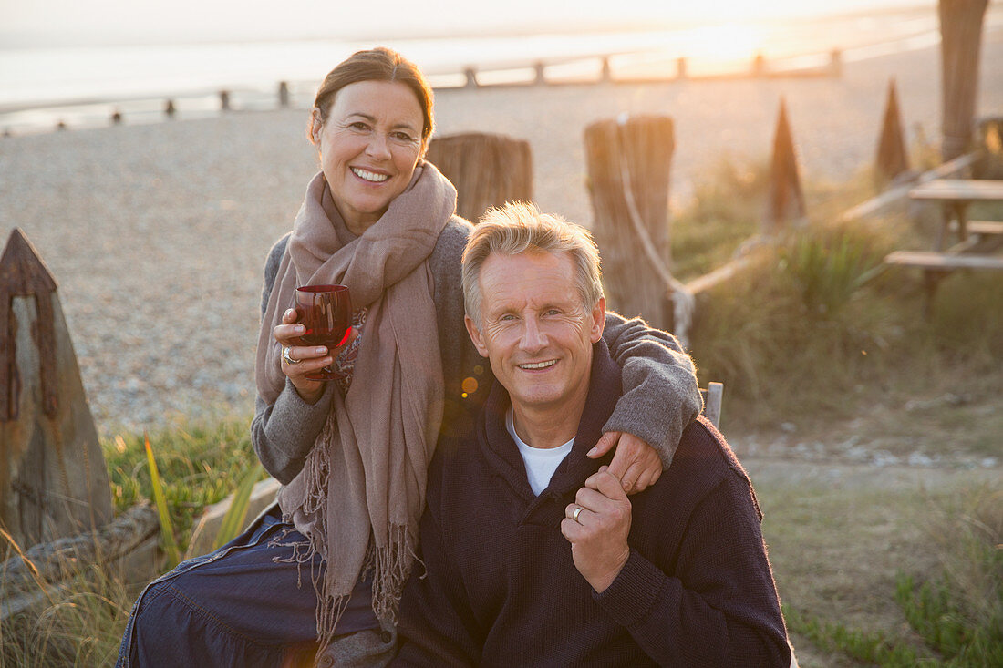 Mature couple holding hands and drinking wine