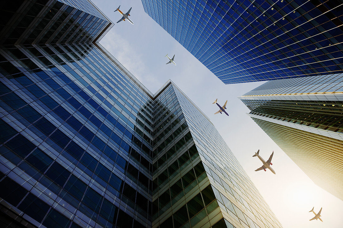 Airplanes flying in a row over highrise buildings
