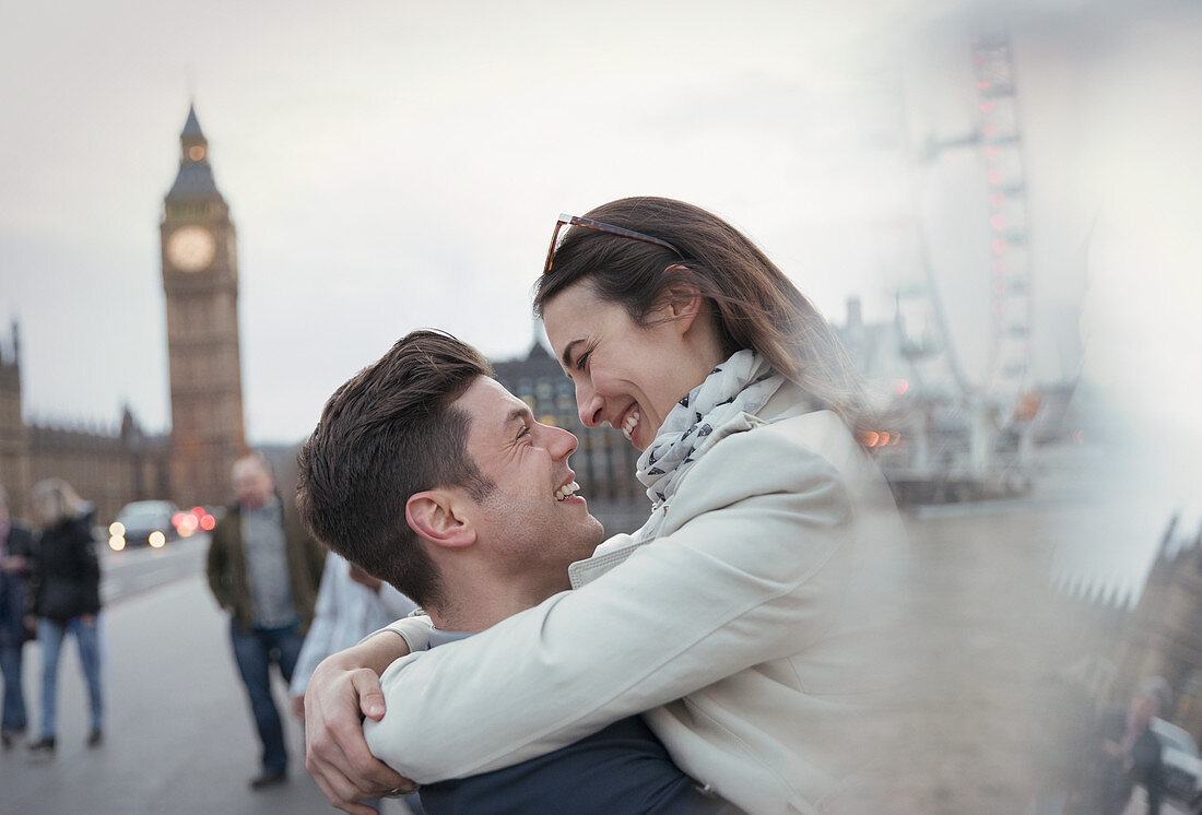 Tourists hugging near Big Ben, London, UK
