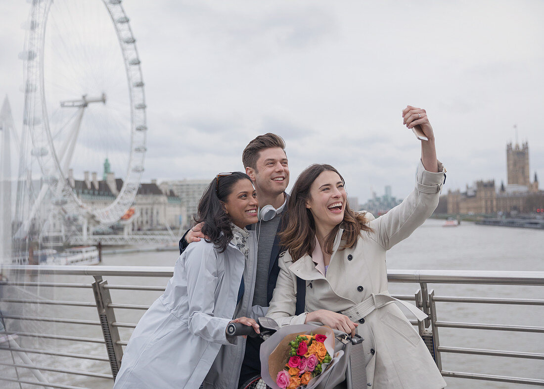 Friends taking selfie, London, UK