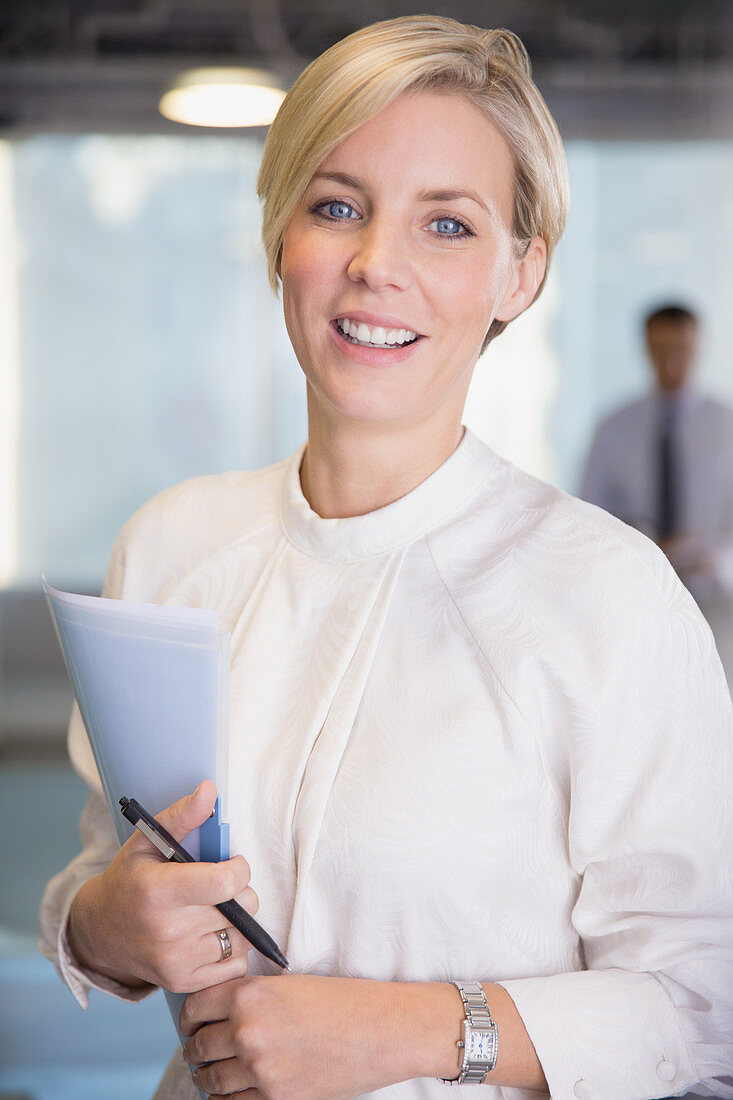 Portrait businesswoman with paperwork