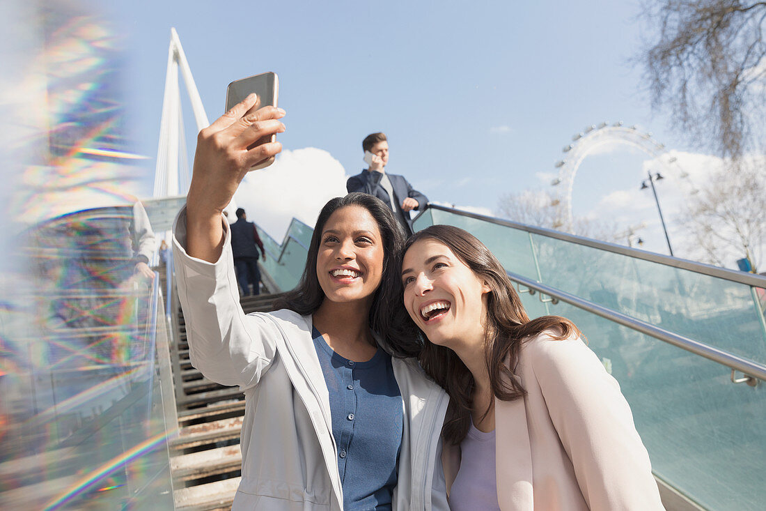 Women friends taking selfie, London, UK