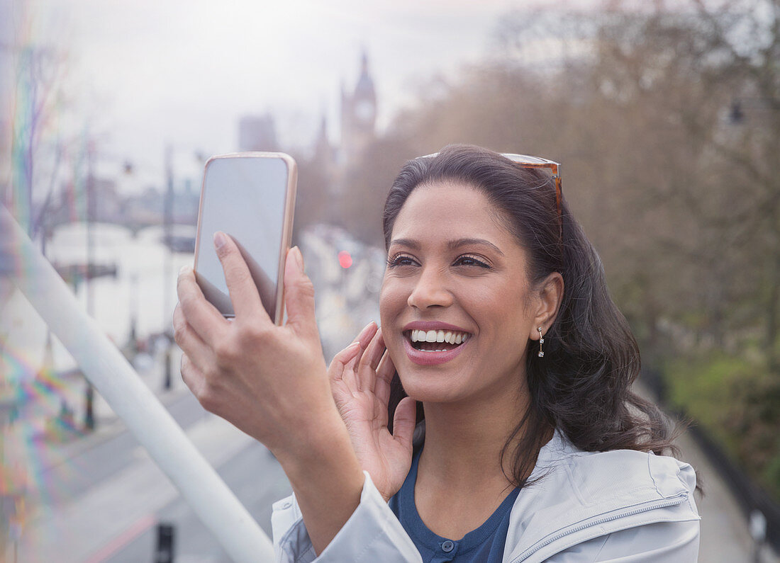 Smiling, woman taking selfie with camera phone