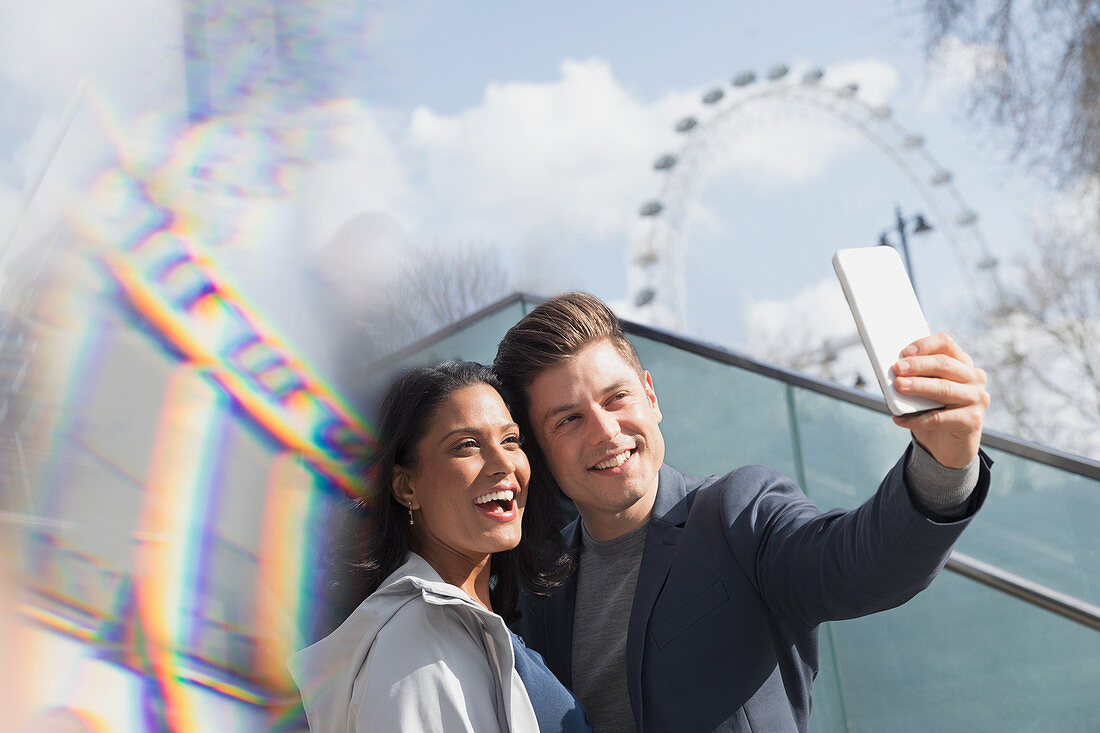 Smiling couple tourists taking selfie, London, UK