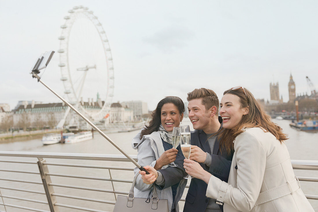 Tourists toasting champagne, London, UK