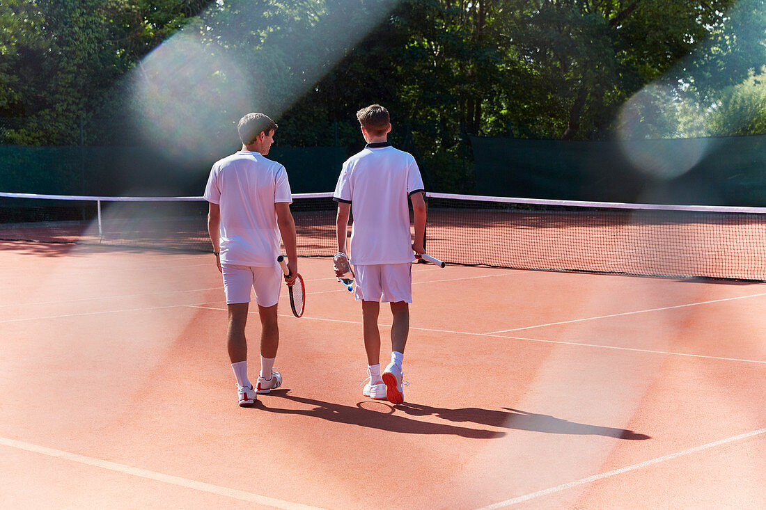 Young tennis players walking with tennis rackets