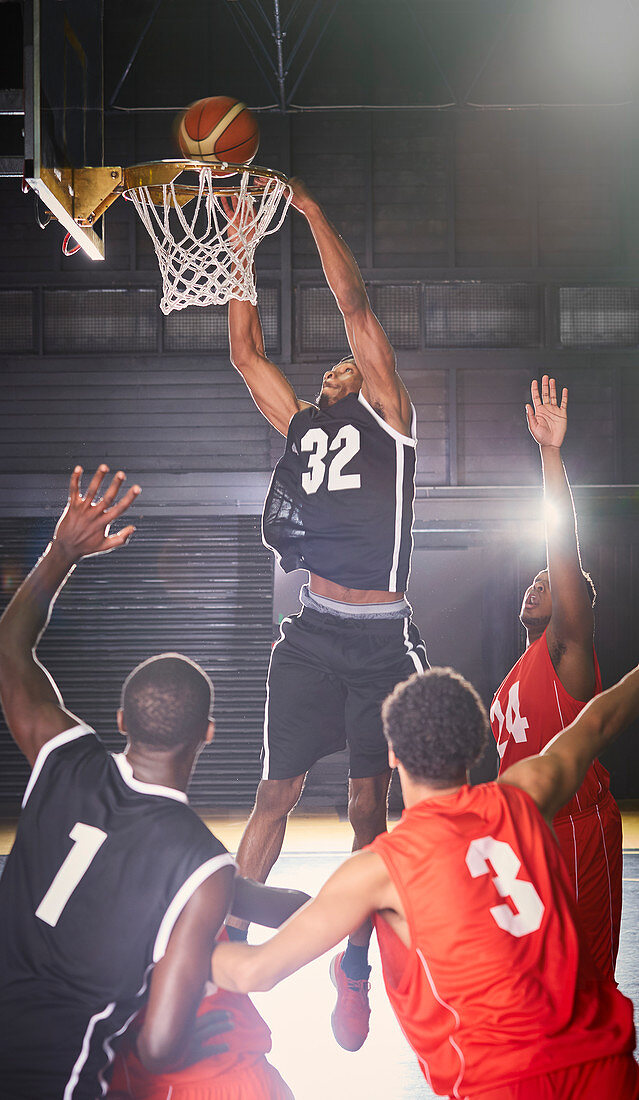 Young basketball player dunking the ball