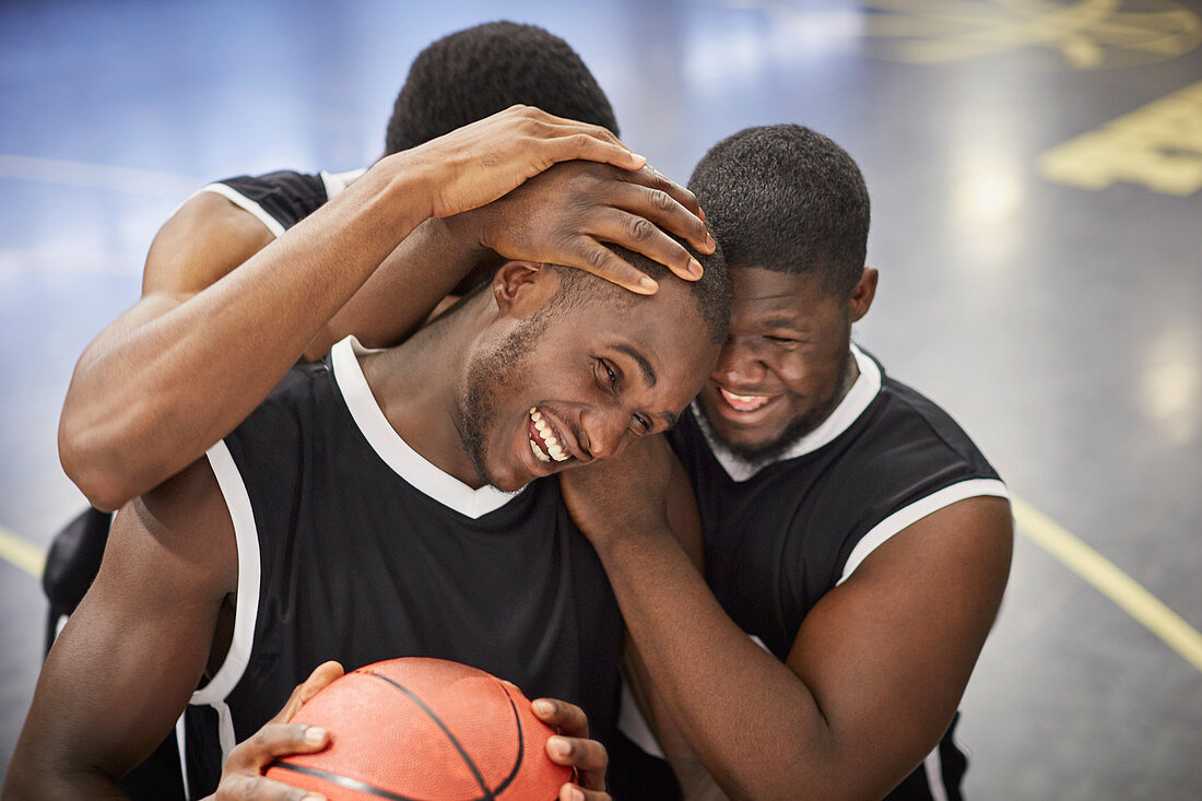 Happy basketball players hugging