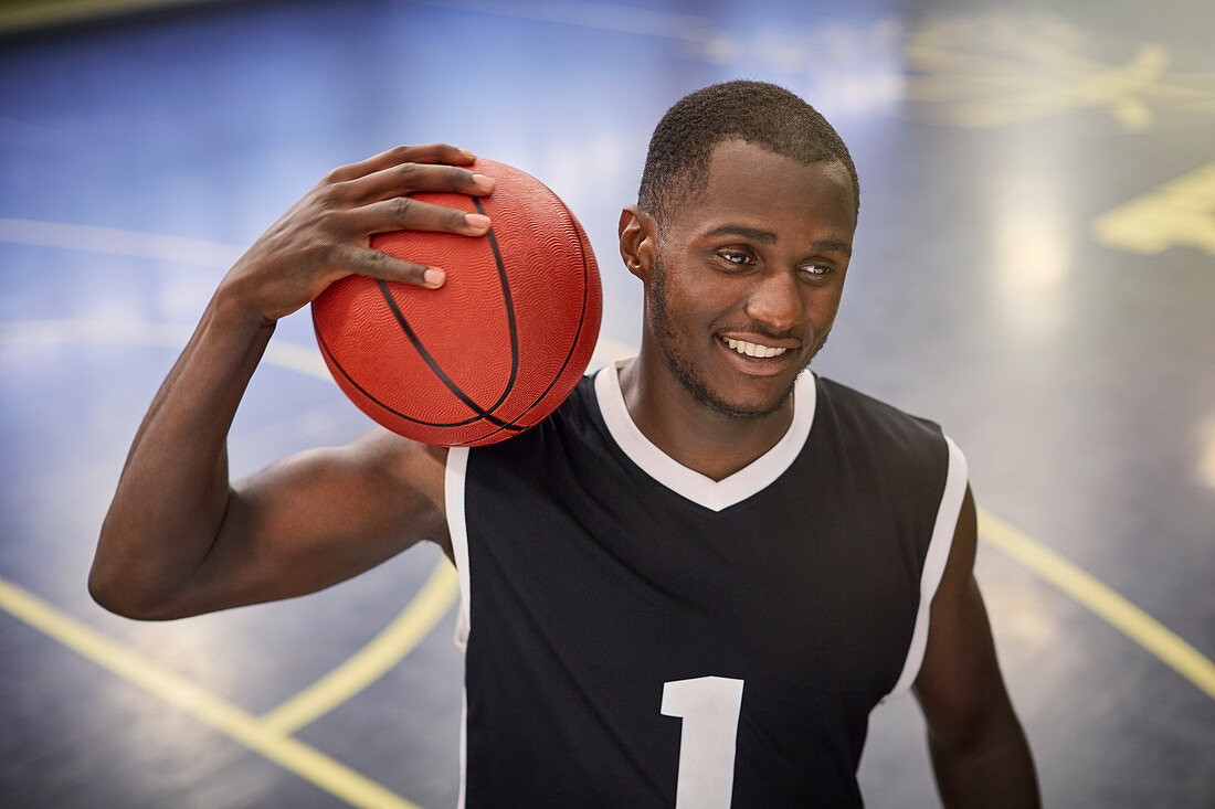 Confident basketball player holding basketball