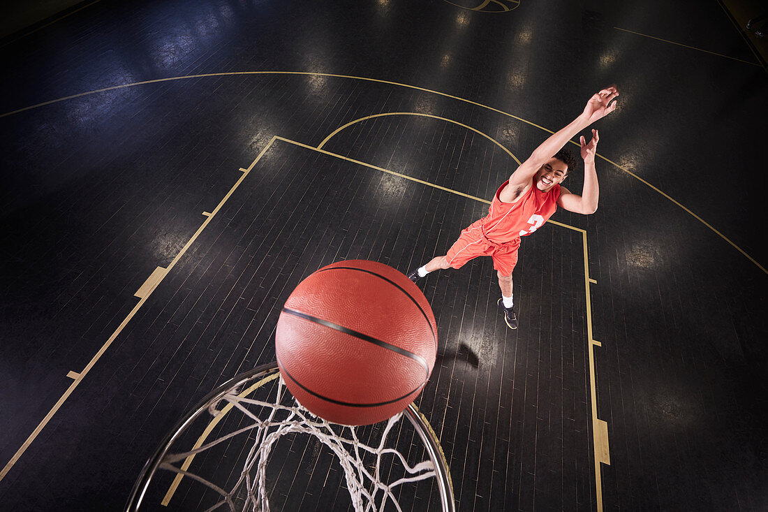 Young basketball player shooting the ball on court