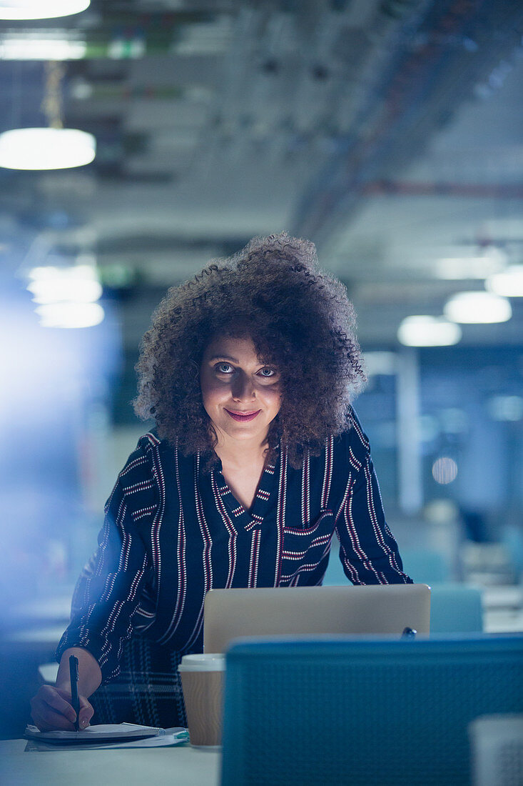 Portrait businesswoman working late at laptop