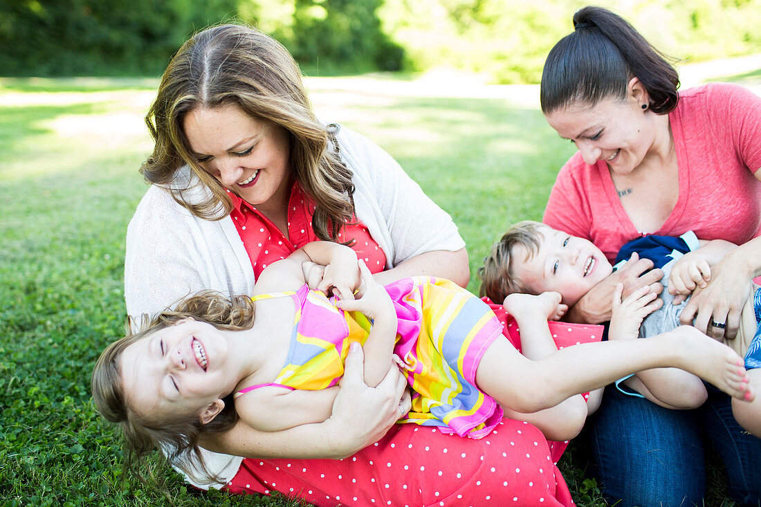 Playful lesbian mothers tickling children