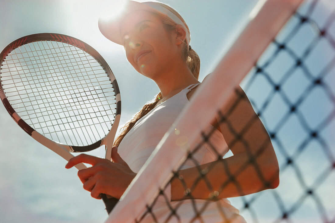 Confident tennis player holding tennis racket