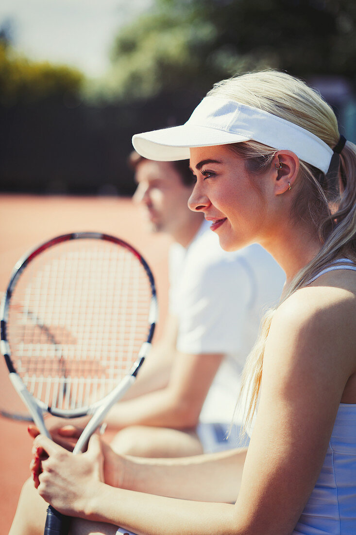 Smiling tennis player holding racket
