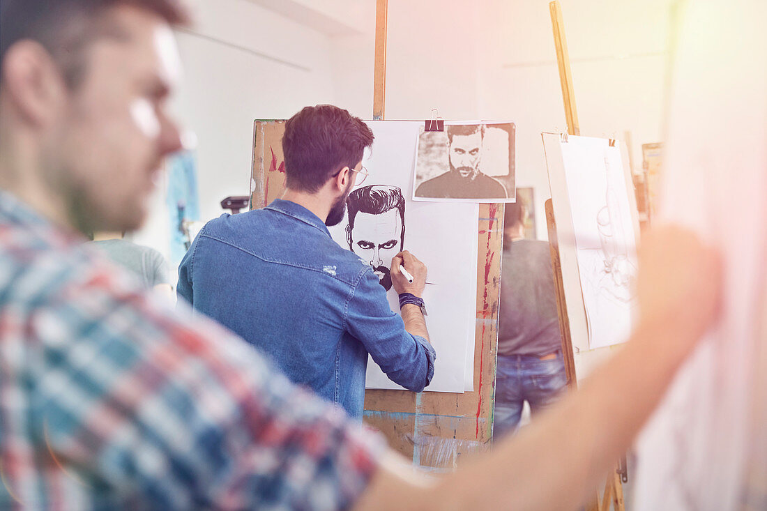 Male artists sketching in art class studio