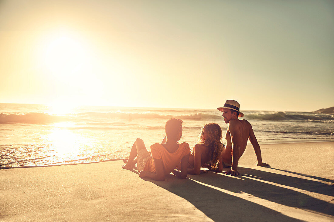 Young friends relaxing on idyllic, beach