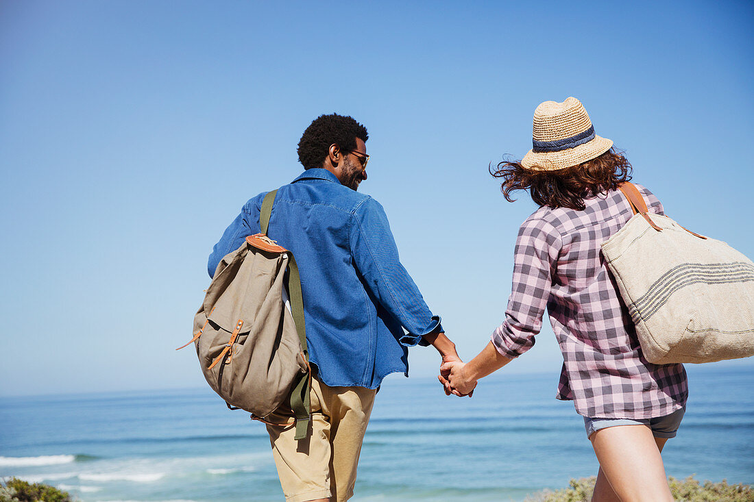 Affectionate couple holding hands, walking