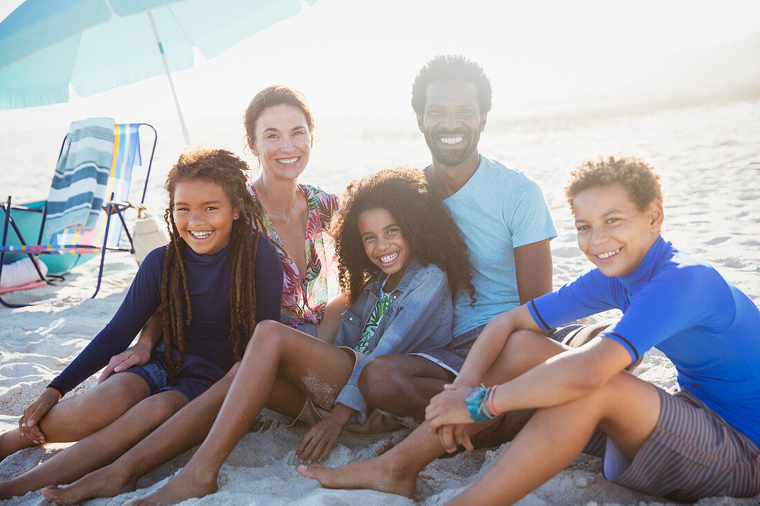 Portrait multi-ethnic family on sunny summer beach