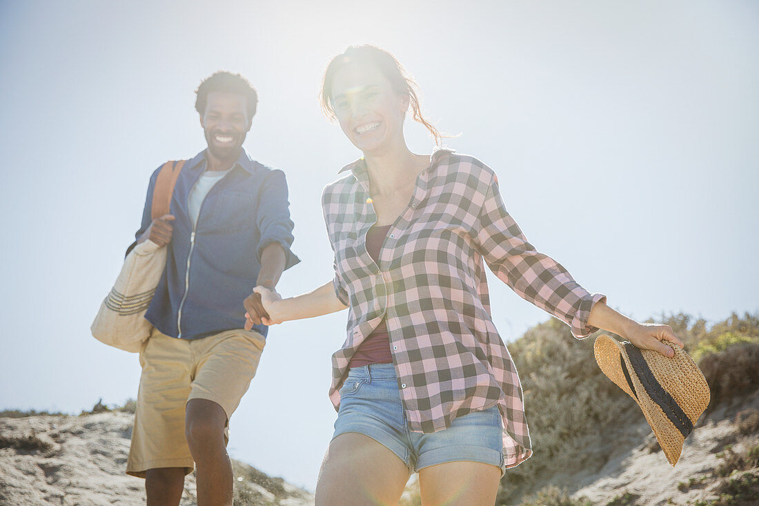 Smiling couple walking on beach path