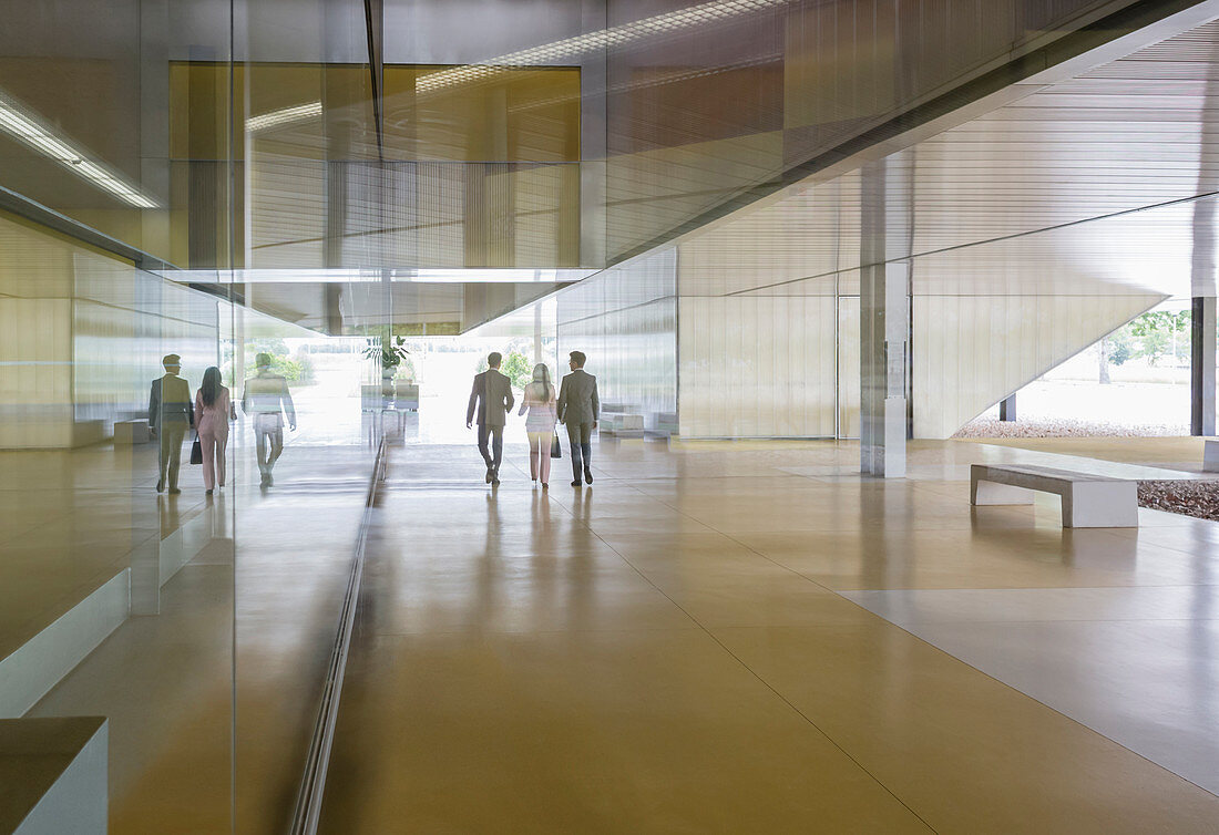 Business people walking lobby corridor