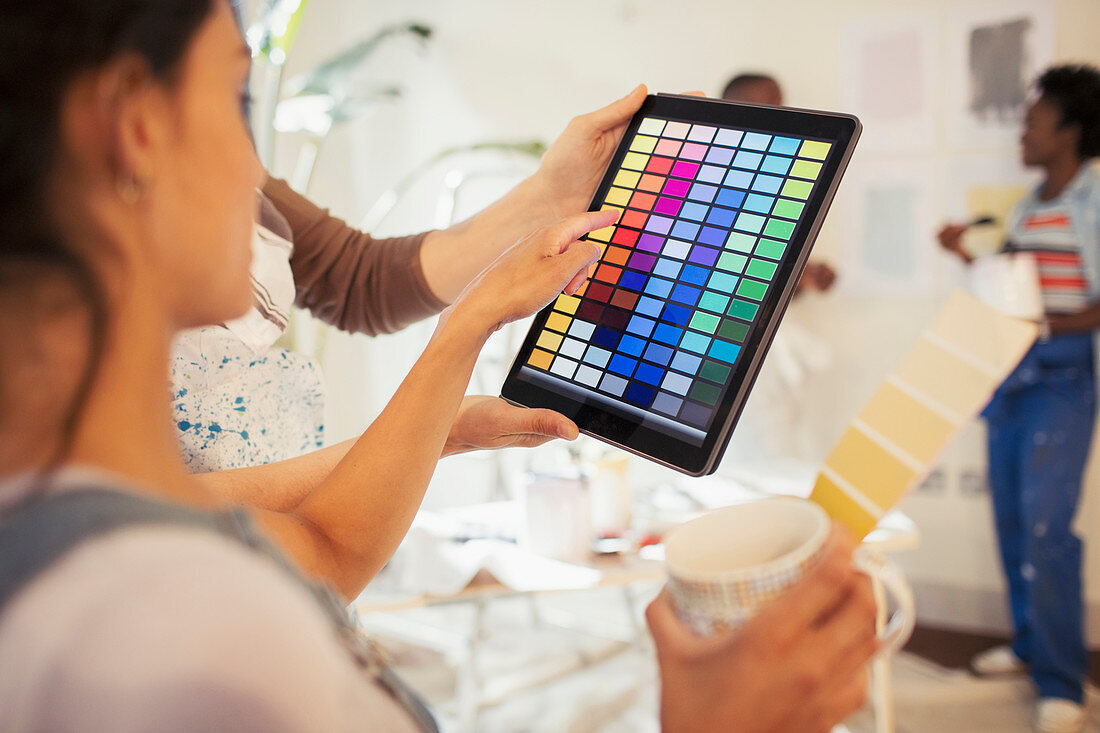 Young woman viewing digital paint swatches
